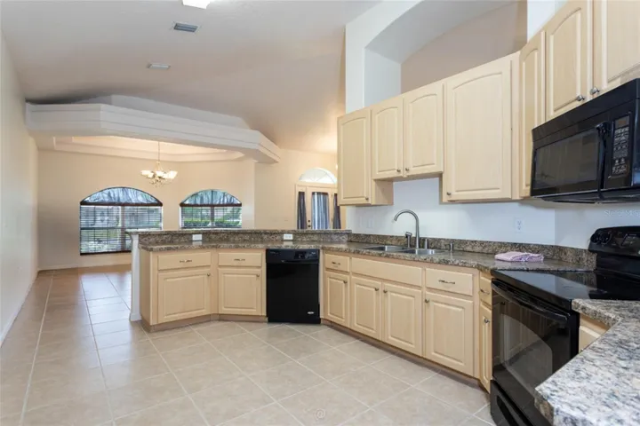 Looking from back of kitchen towards dining room and front of house,