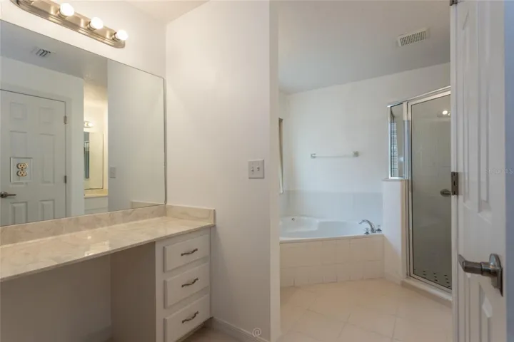Primary bath has make-up vanity with large mirror
