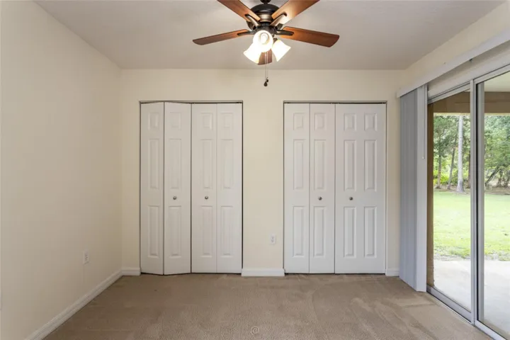 Bedroom #4 is in the back of the home and has access to the open lanai.  Perfect for an office. Look at all of that closet space.