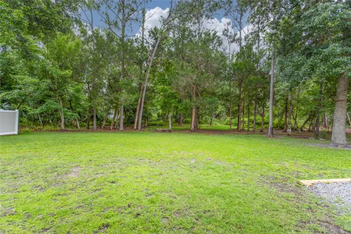 Open, private yard, backs to large wooded area.