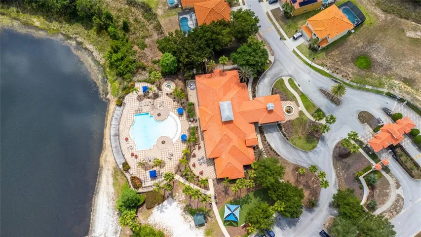 Bird's eye view of the guard gate, clubhouse community pool, playground and waterfront gazebo