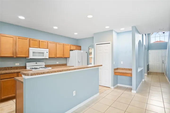 Kitchen with bar top island and work station