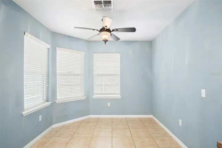 Dining nook with a triple window view