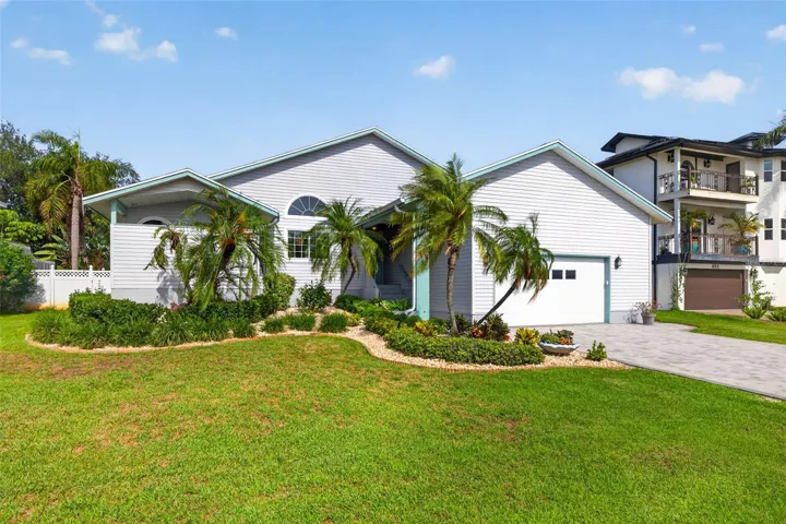 Nicely landscaped with freshly painted trim and new driveway pavers