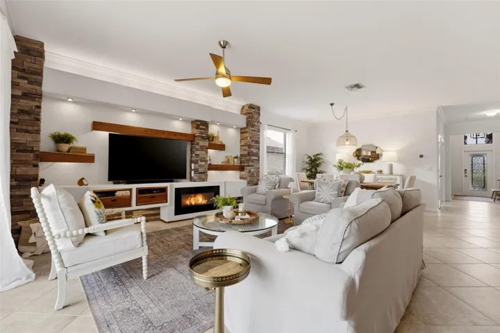 Living Room with custom built in shelves, LED lighting, electric fireplace