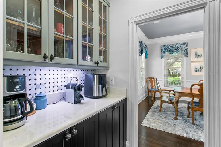 Enjoy added convenience with a dry bar off the dining room, perfect for entertaining or your morning coffee routine which connects to the kitchen