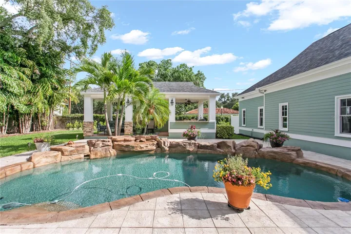 The backyard retreat complete with a pool, outdoor kitchen, cabana space, and generous green space designed for entertaining.