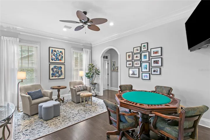 Currently used as a secondary lounge space, the formal living room is ideal for movie nights, card games, and entertaining