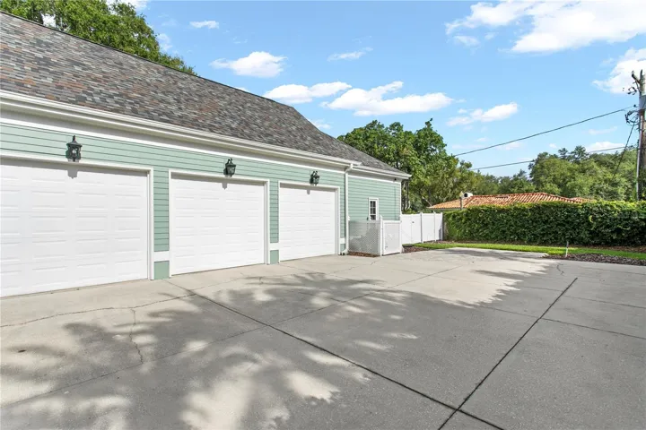 The home features a three-car garage and two parking pads, offering ample space for multiple vehicles.