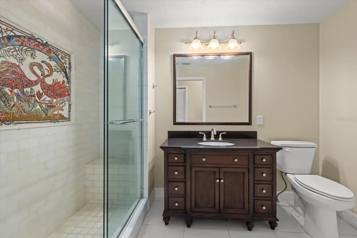 Full Bath with Walkin Shower with decorative mosaic tile.