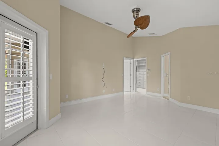 Primary Suite with decorative ceiling fan