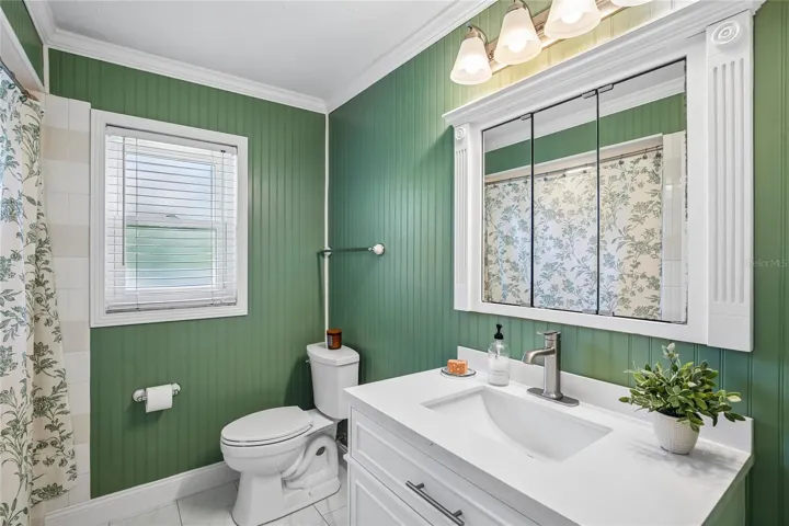 Renovated Bathroom with new vanity, marble floors, bead board, fixtures and shower