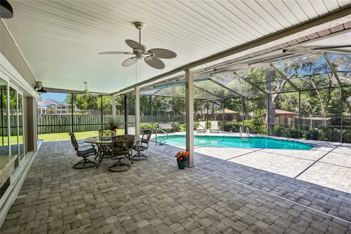 Gorgeous Lanai with stunning pavers.  Look at the back yard oasis