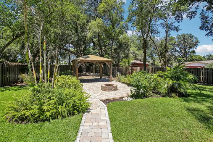 Paved walkway to back yard gazebo and fire pit