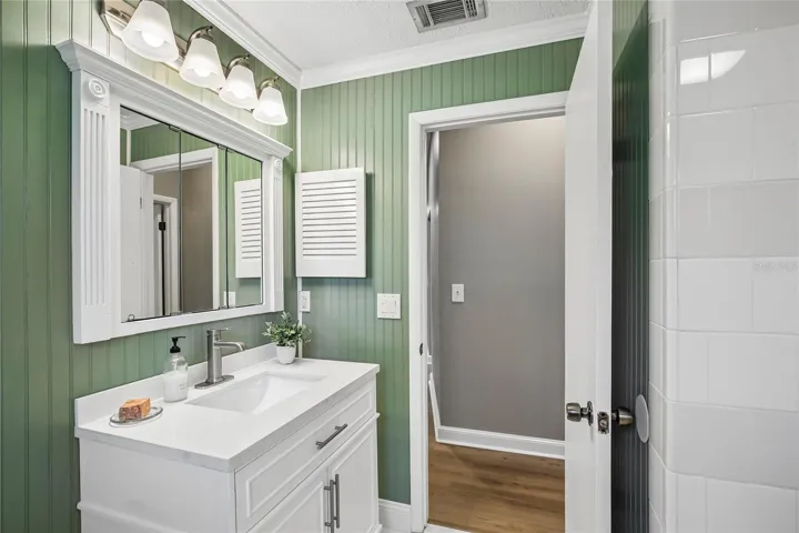 Renovated Bathroom with new vanity, marble floors, bead board, fixtures and shower