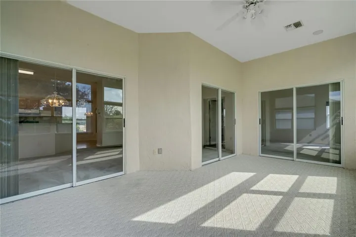 Florida Room with sliders leading to Great Room on the left and Primary Bedroom at the nd