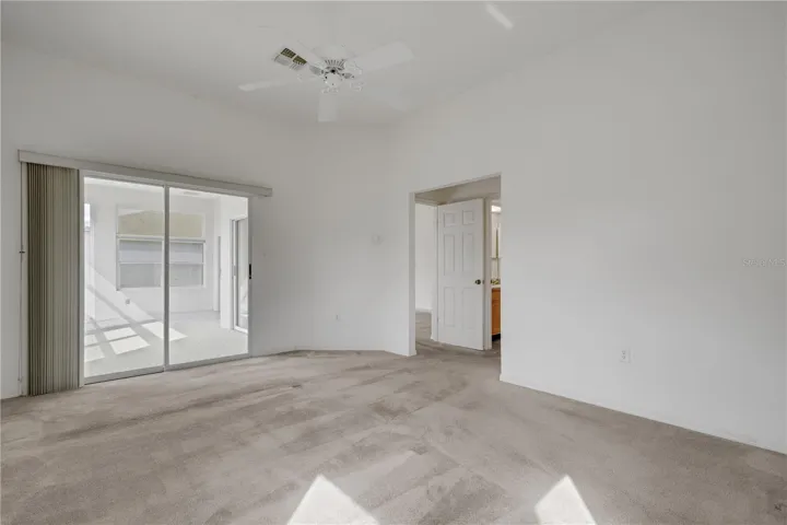 Primary Bedroom with sliders leading out to Florida Room