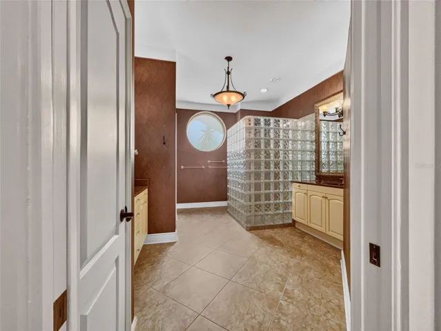 Primary bathroom with dual sinks cabinets, walk-in shower.