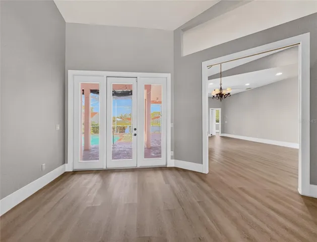Living room with pool and lake view. New luxury vinyl plank floors.