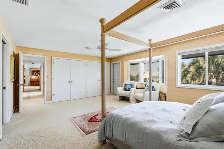 Primary Suite on upper level offers 2 closets plus a walk-in closet and direct access out to the balcony overlooking the Gulf