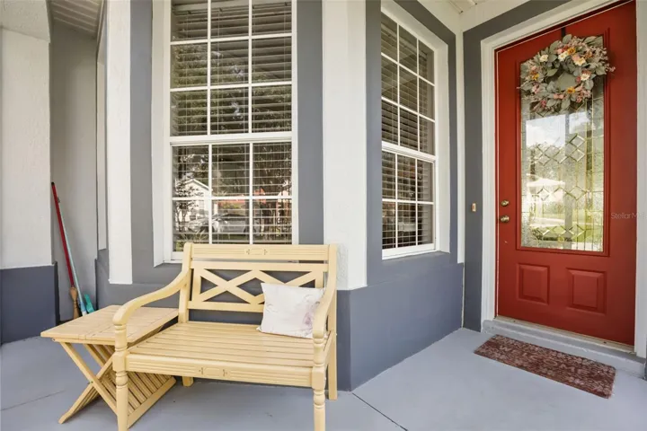 Welcoming front entry with covered seating area and charming curb appeal.