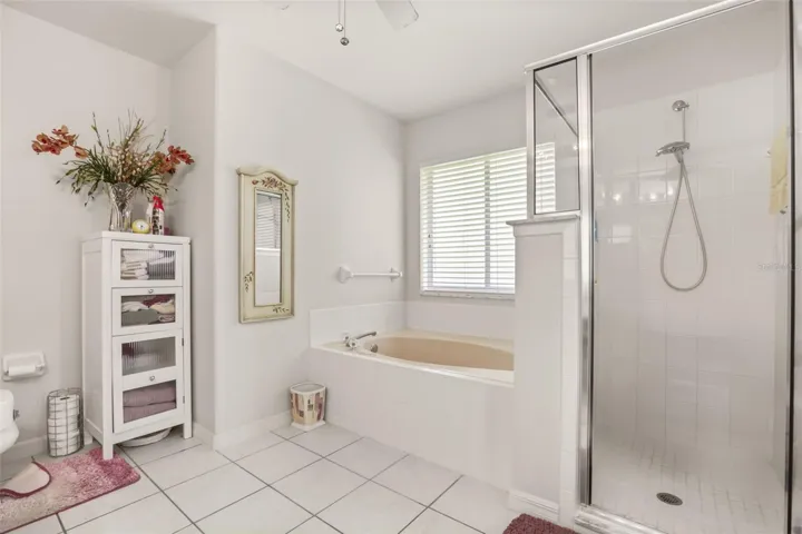Relaxing primary bath featuring a garden tub and separate walk-in shower.