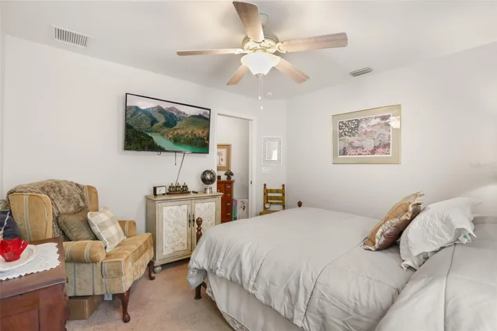 Spacious guest bedroom offering comfort, privacy, and plenty of natural light.