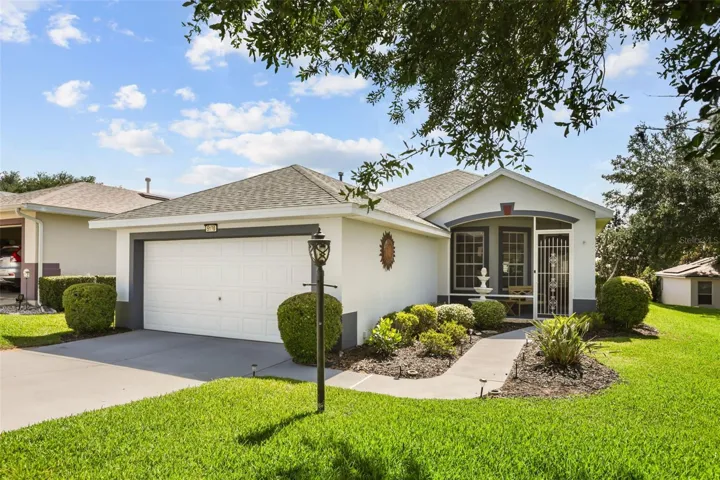Beautiful curb appeal welcomes you home with manicured landscaping, a spacious driveway, and a charming front entry.