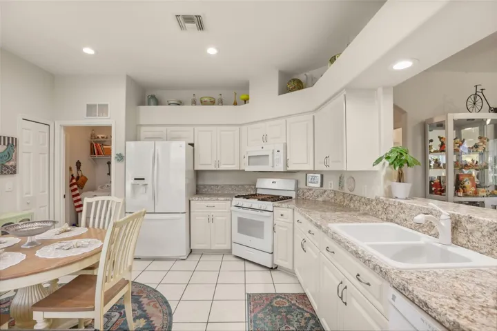 Large kitchen offering ample cabinet storage, generous counter space, and a functional layout.