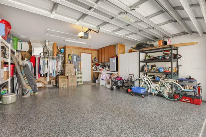 Spacious two-car garage with epoxy flooring, excellent organization potential, and additional storage space.