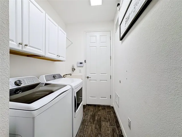laundry room with built in upper cabinets