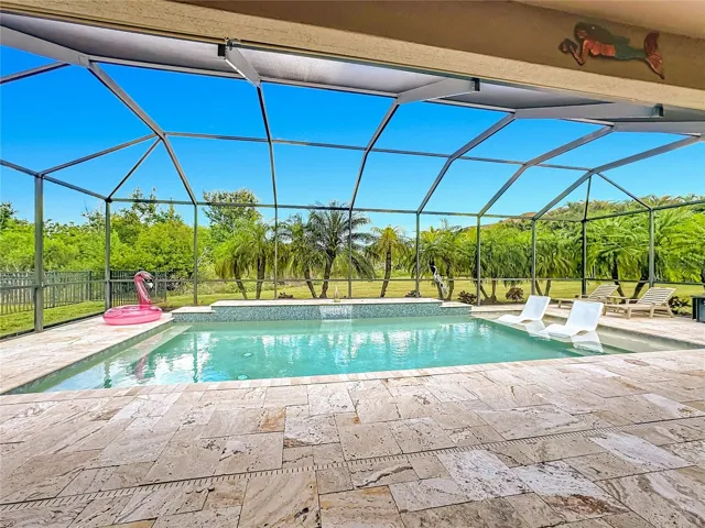 Travertine Tile surrounding the pool and on lanai.  Baby gate fences are included!