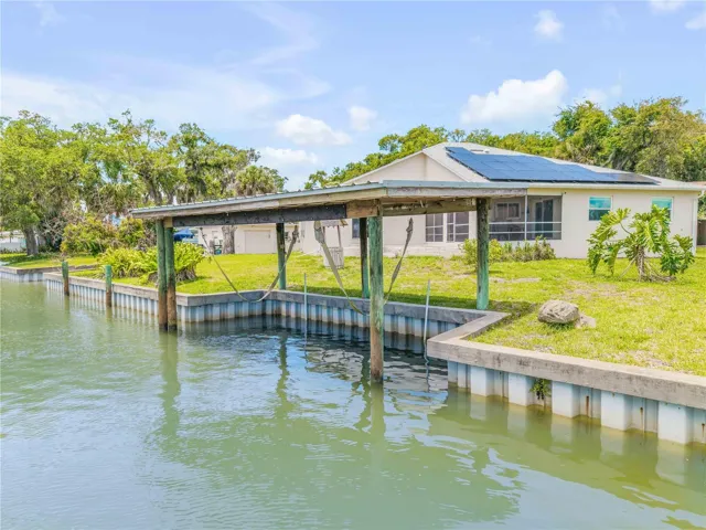 BOAT HOUSE ON SIDE IN CANAL