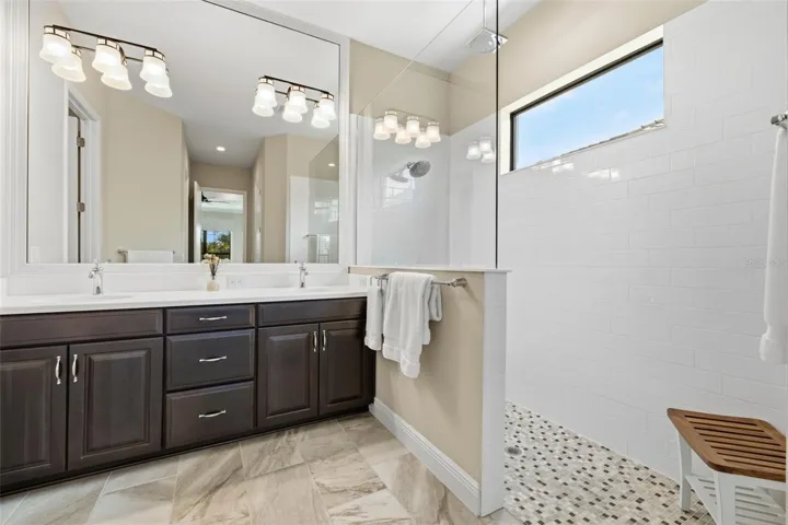 Primary bathroom with dual sinks and form fitted seamless Corian countertops