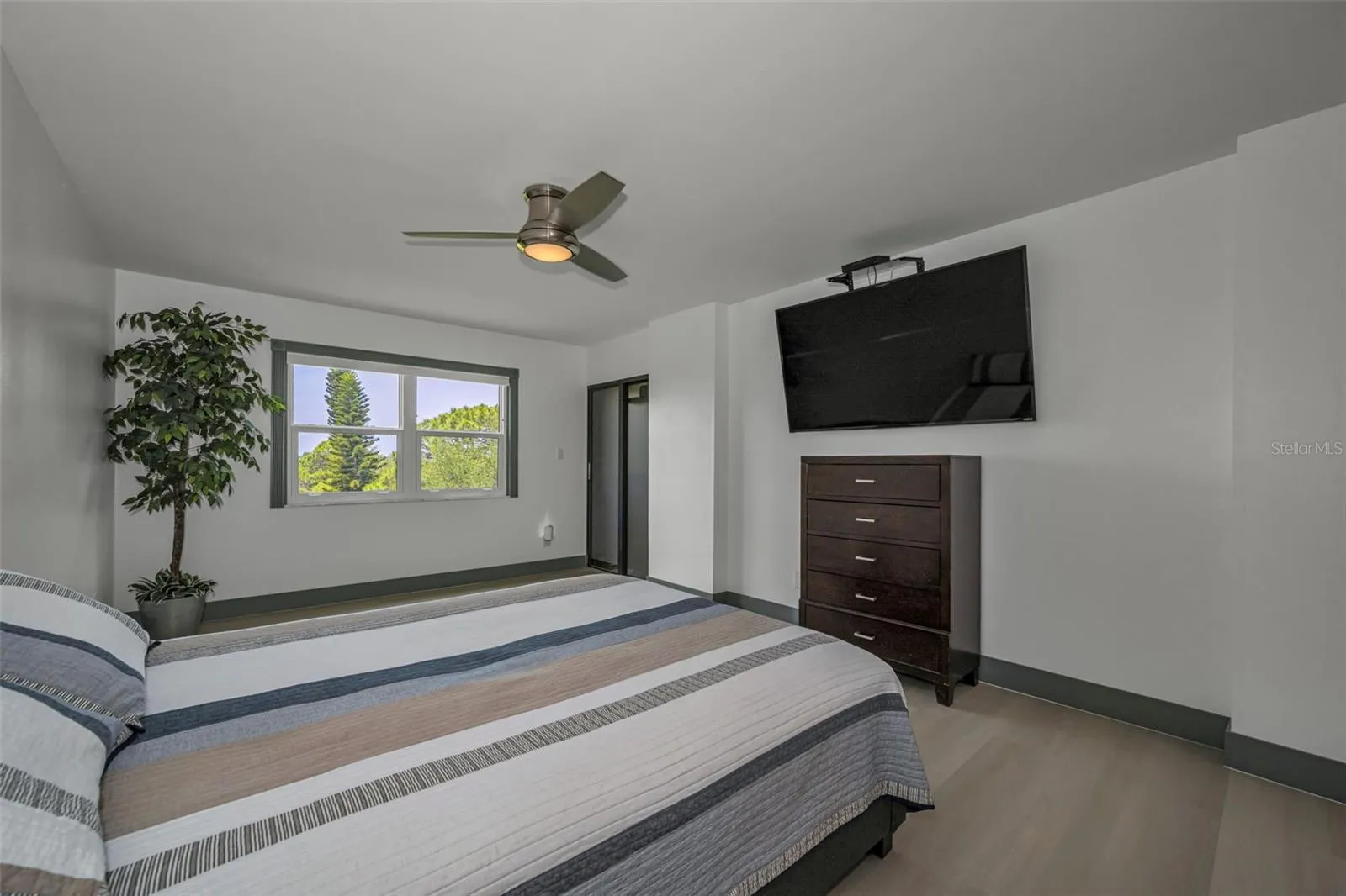 Primary Bedroom, Slider to balcony, new vinyl random plank flooring.