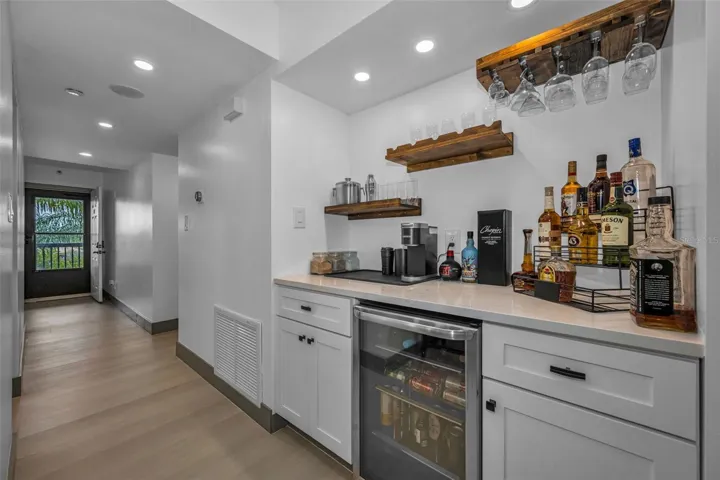 At entrance find luxury vinyl plank flooring throughout.  Dry bar with wine refrigerator with Quartzite counter.  Speccial thermostat on wall to control air conditioning from  where ever you are located.