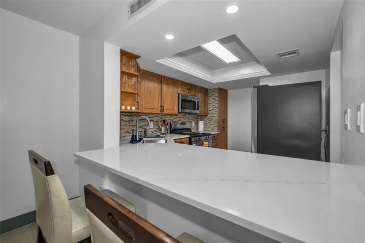 New Quartzite counters in the kitchen and overhead lighting.