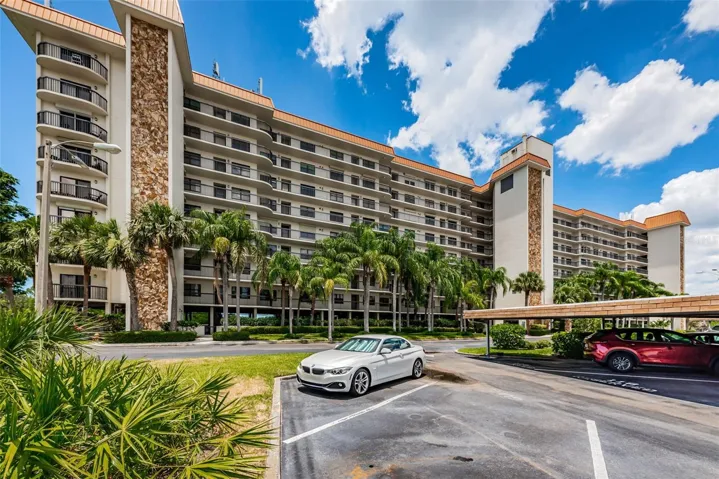 A very Tropical view of Otter Key!  Curved units and balconies on the ends of the building make this a stunning architectural feature; with under building parking and plush Palm Trees!