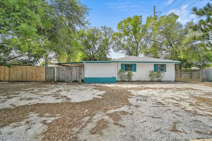 Parking for multiple vehicles and the front entrance to the home is behind the gate.