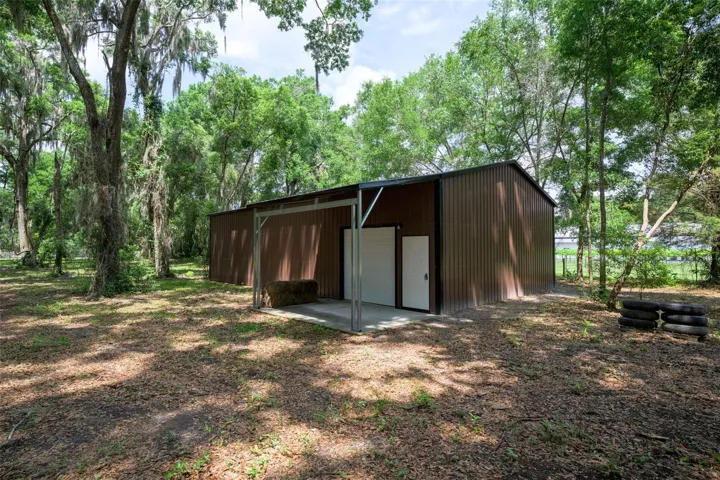 30x50 workshop with a concrete floor, power, shop lights, and multiple outlets. The shop includes two powered bay doors—one 8x8 and one 10x10—and a covered porch, making it ideal for vehicles, equipment, or a home-based business.