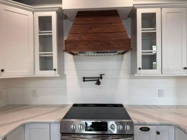 Custom hood vented to the outside. pot filler
