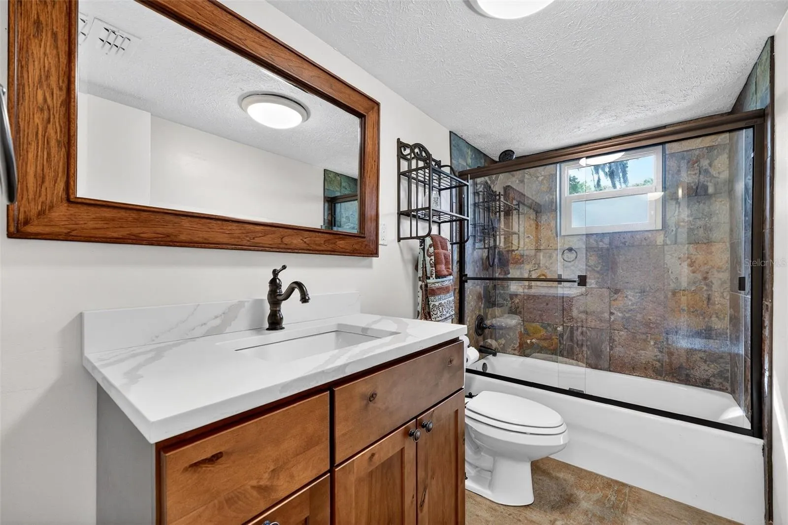 Second floor bath. Tub/shower combo with rain head shower head.