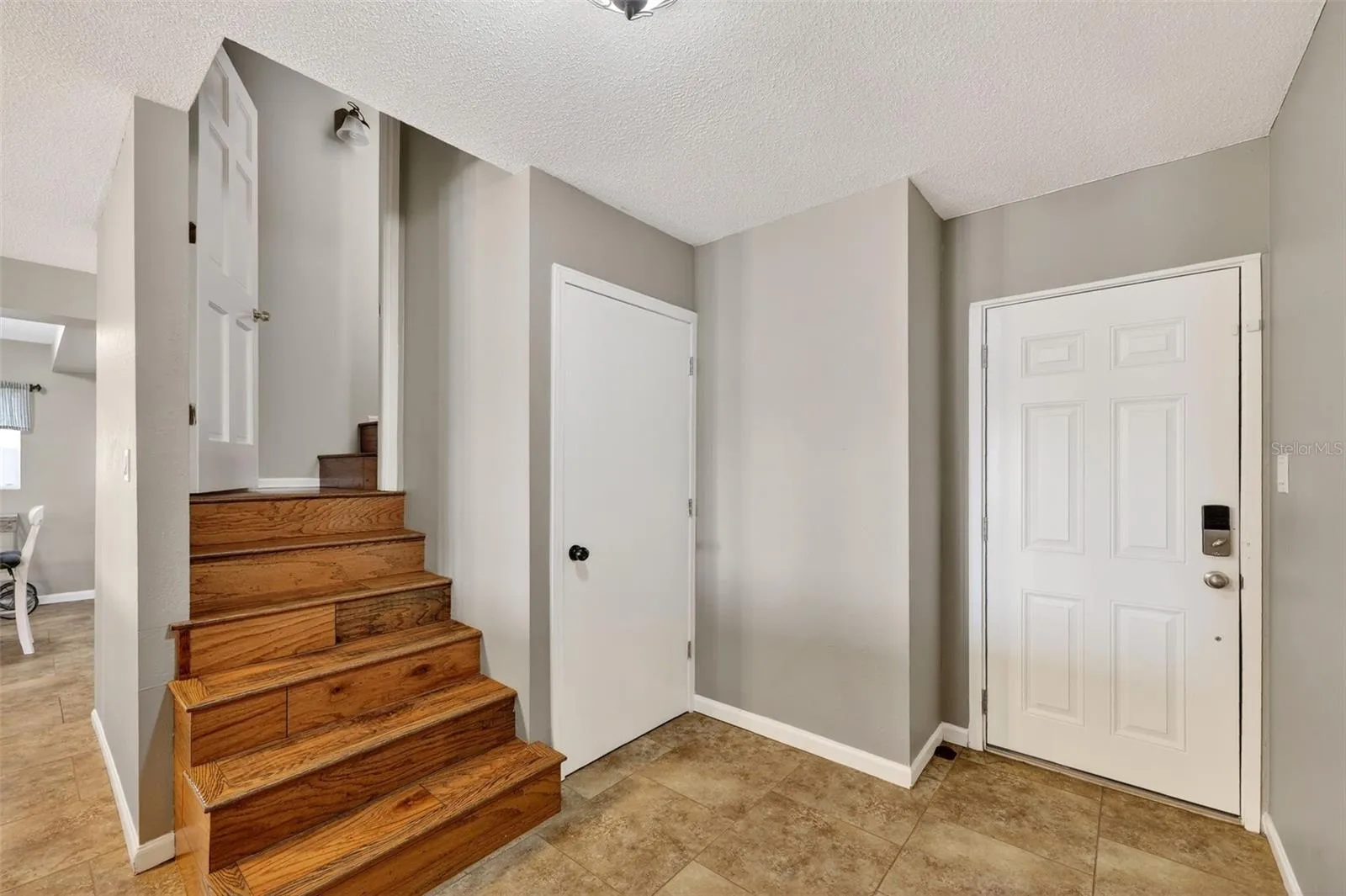 Stairs to first level. Door to right goes out side. middle door is storage.