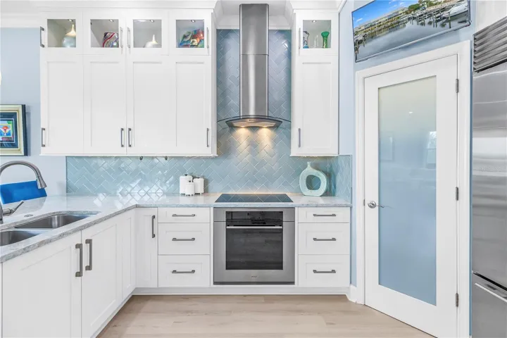 Upper Cabinets Extend to Ceiling with Lighted Display Cabinets