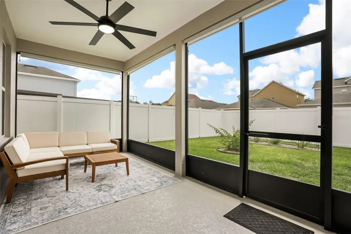 Huge screened lanai with views of your recently fenced backyard makes it a great space for your morning coffee or nighttime beversge of choice. They also added a new fan for those Summer days!