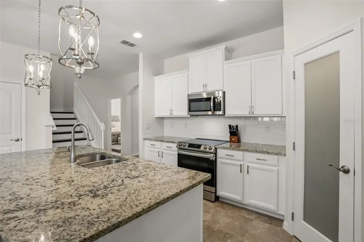 Chef's kitchen with all new fixtures, hardware, soft close cabinets, tiled back splash,  and the brand new Bosch dishwasher & Frigidaire refrigerator have exyended 5 yr warranties.  New wood shelving in your walk-in pantry too