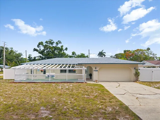 Fenced in front porch area.  Double gate to the right for access to covered carport parking.