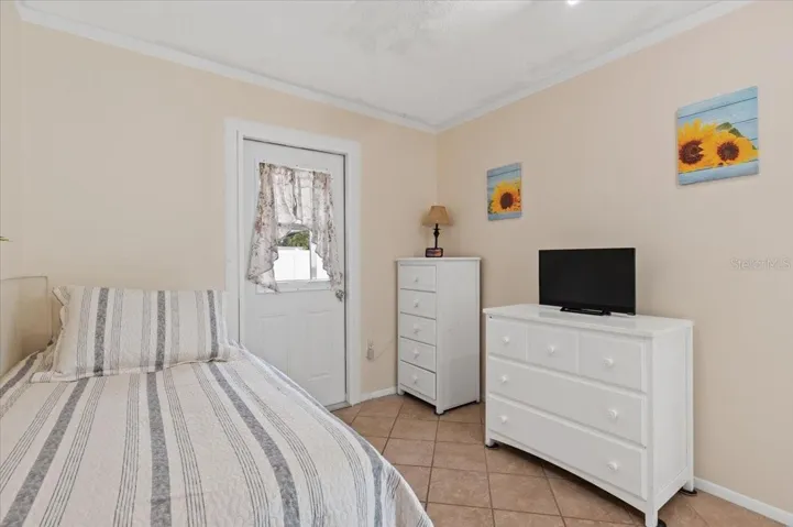 Bonus room, currently used as a bedroom.  Access to a back patio.