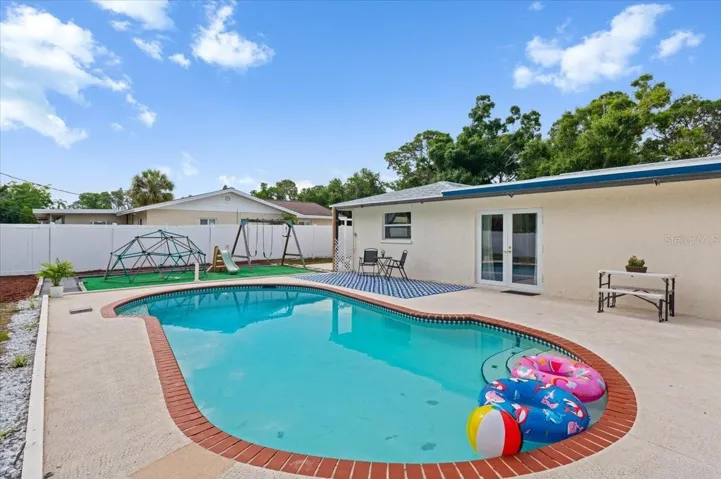 Pool deck with adjacent play area.