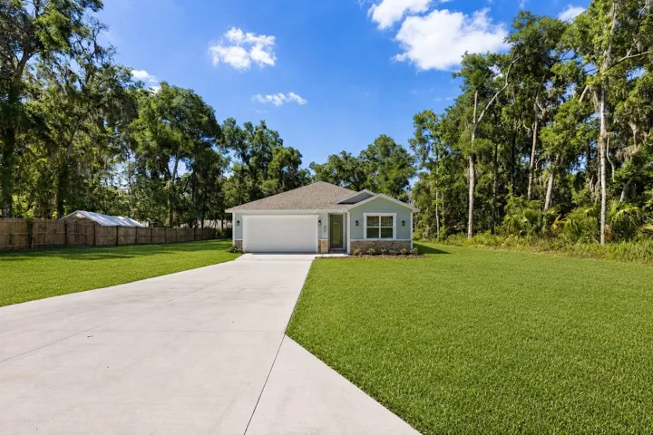Long driveway with ample parking space leading to the home